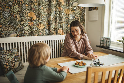 Mother with child sitting at table