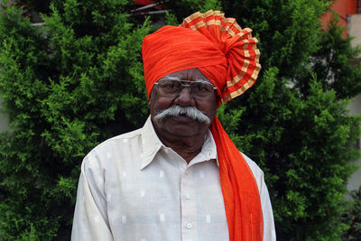 Portrait of senior man against plants