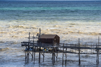 Lifeguard hut on beach against sky