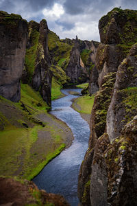 Scenic view of waterfall against sky