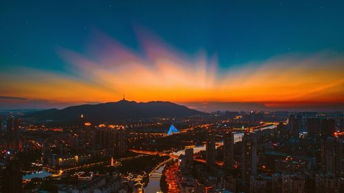 High angle view of illuminated buildings against sky during sunset