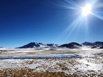 Scenic view of snowcapped mountains against clear blue sky