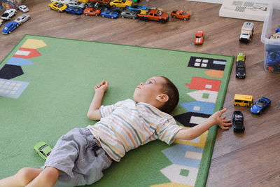 Child with cerebral palsy playing on mat, having fun. kid having physical and mental problem
