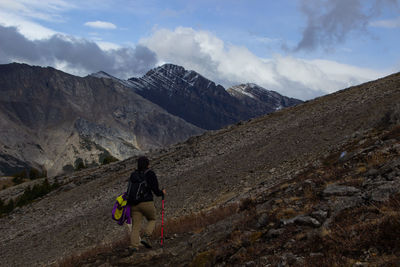 Woman hiker walking through the beautiful canadian rockies in autumn on a beautiful sunny day 
