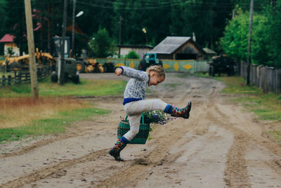 Full length of boy playing on land