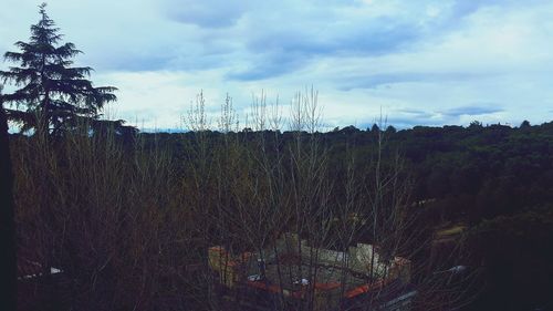 Scenic view of field against cloudy sky