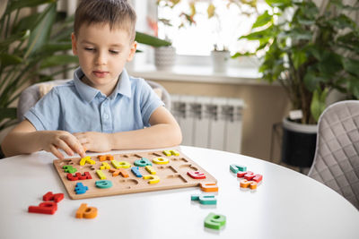 Portrait of boy playing with toy blocks on table