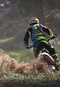 Rear view of man riding motorcycle