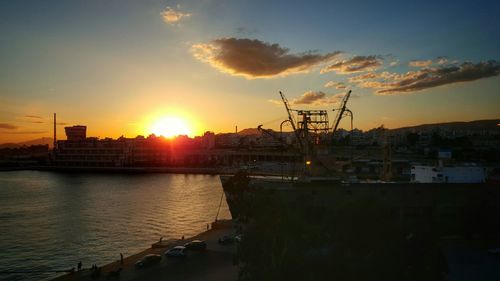 Boats in harbor at sunset