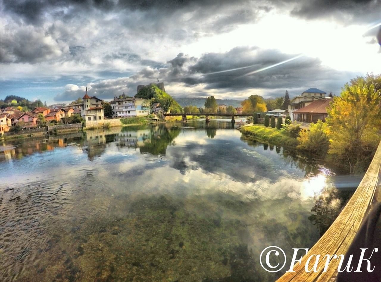 water, architecture, built structure, building exterior, river, reflection, cloud - sky, sky, connection, bridge - man made structure, travel destinations, cloudy, waterfront, engineering, cloudscape, cloud, day, town, outdoors, tourism, canal, scenics, tranquility, standing water, tranquil scene, bridge