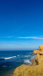 Scenic view of sea against blue sky