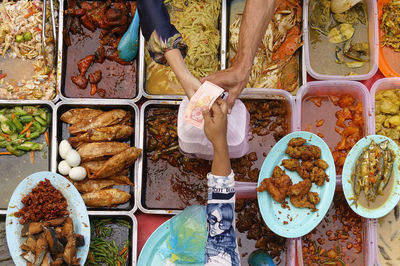 Directly above shot of woman selling food at stall