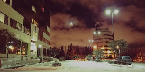 Illuminated city against sky at night during winter