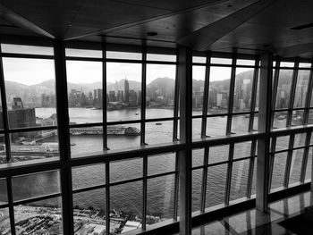 Buildings and sea seen through window