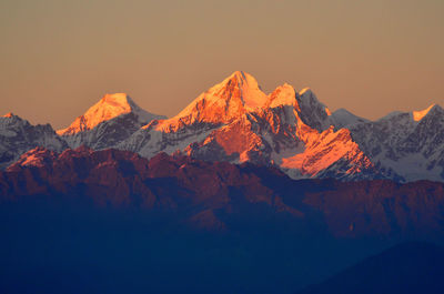 Scenic view of snowcapped mountains against sky during sunset