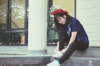 Side view of man sitting on table