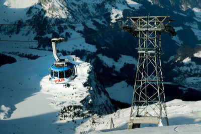 Overhead cable car in snow covered mountains