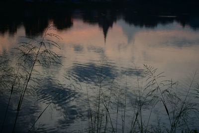 Scenic view of lake against sky at sunset