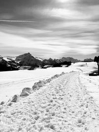 Surface level of snow covered land against sky