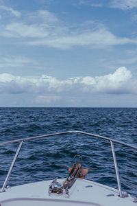 People sailing on sea against sky