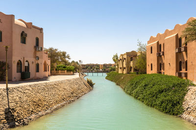 Panoramic view of buildings against clear blue sky