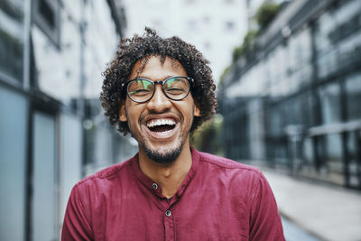 Portrait of smiling young man standing outdoors