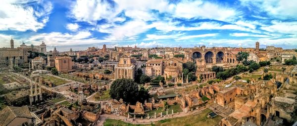 Panoramic view of cityscape against cloudy sky