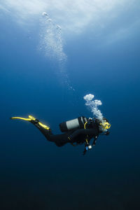 Young woman scuba diving in sea