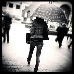 Woman with umbrella in background