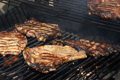 High angle view of meat on barbecue grill