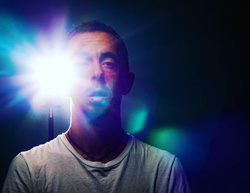 Mid adult man in illuminated room