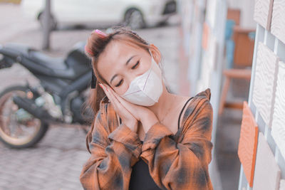 Portrait of young woman standing outdoors