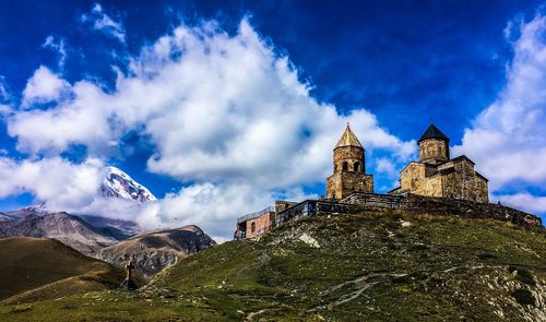 Low angle view of temple building against cloudy sky