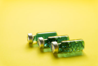 Close-up of toy car on table against yellow background