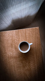 High angle view of coffee cup on table