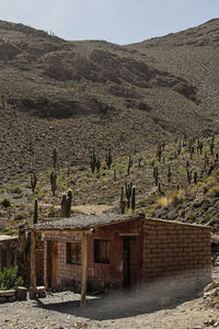 Built structure on landscape against mountain range