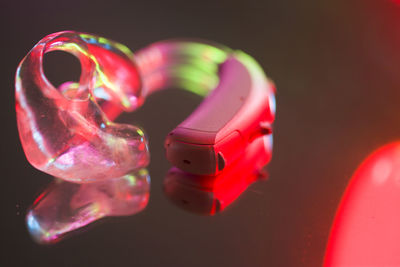 Close-up of toys on table against black background