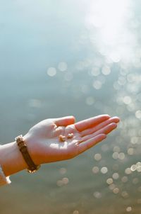 Close-up of cropped hand holding water