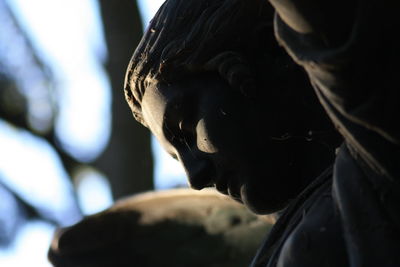 Low angle view of angel statue in cemetery