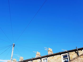 Low angle view of buildings against clear blue sky