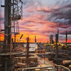 Factory against sky during sunset