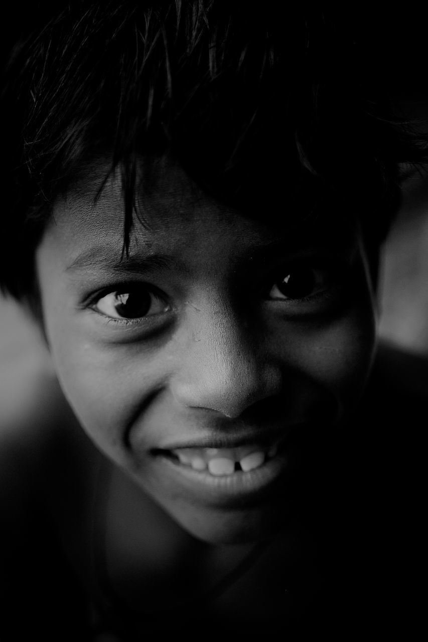 portrait, looking at camera, headshot, one person, close-up, child, childhood, smiling, real people, front view, boys, indoors, males, happiness, lifestyles, men, emotion, human face, innocence