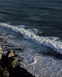 High angle view of waves rushing towards shore