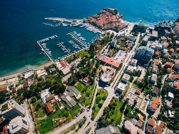 High angle view of buildings by sea in city