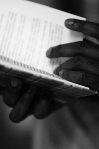 Midsection of man holding paper