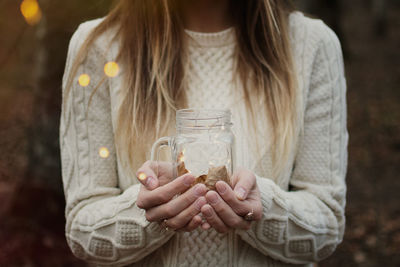 Midsection of a woman drinking glass