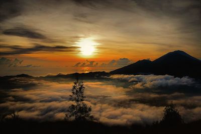 Scenic view of dramatic sky over landscape during sunset