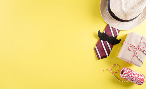 High angle view of hat on floor against yellow background