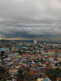 Cityscape against cloudy sky