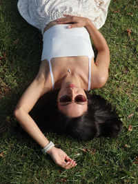 Low section of woman sitting on grass